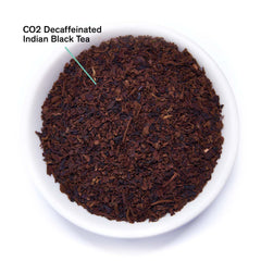 August Essentials Decaf Black Black Tea loose leaves displayed in a white bowl, highlighting the product's natural appearance.