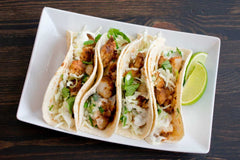 Wild Alaskan Cod grilled and served as tacos with cabbage and lime