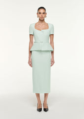 Front view of a model wearing the Peplum Wool Silk Midi Dress in Mint