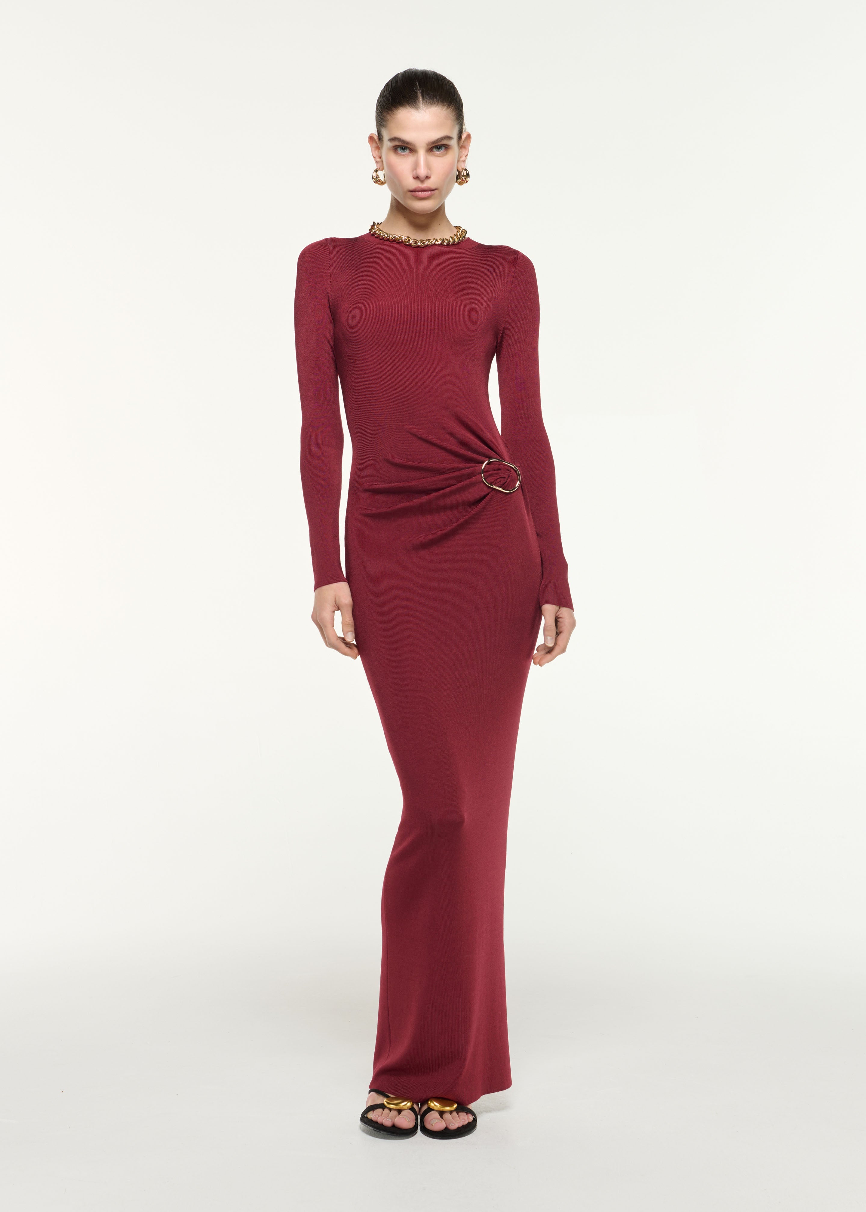 Front view of a model wearing the Gathered Buckle Knit Maxi Dress in Dark Red