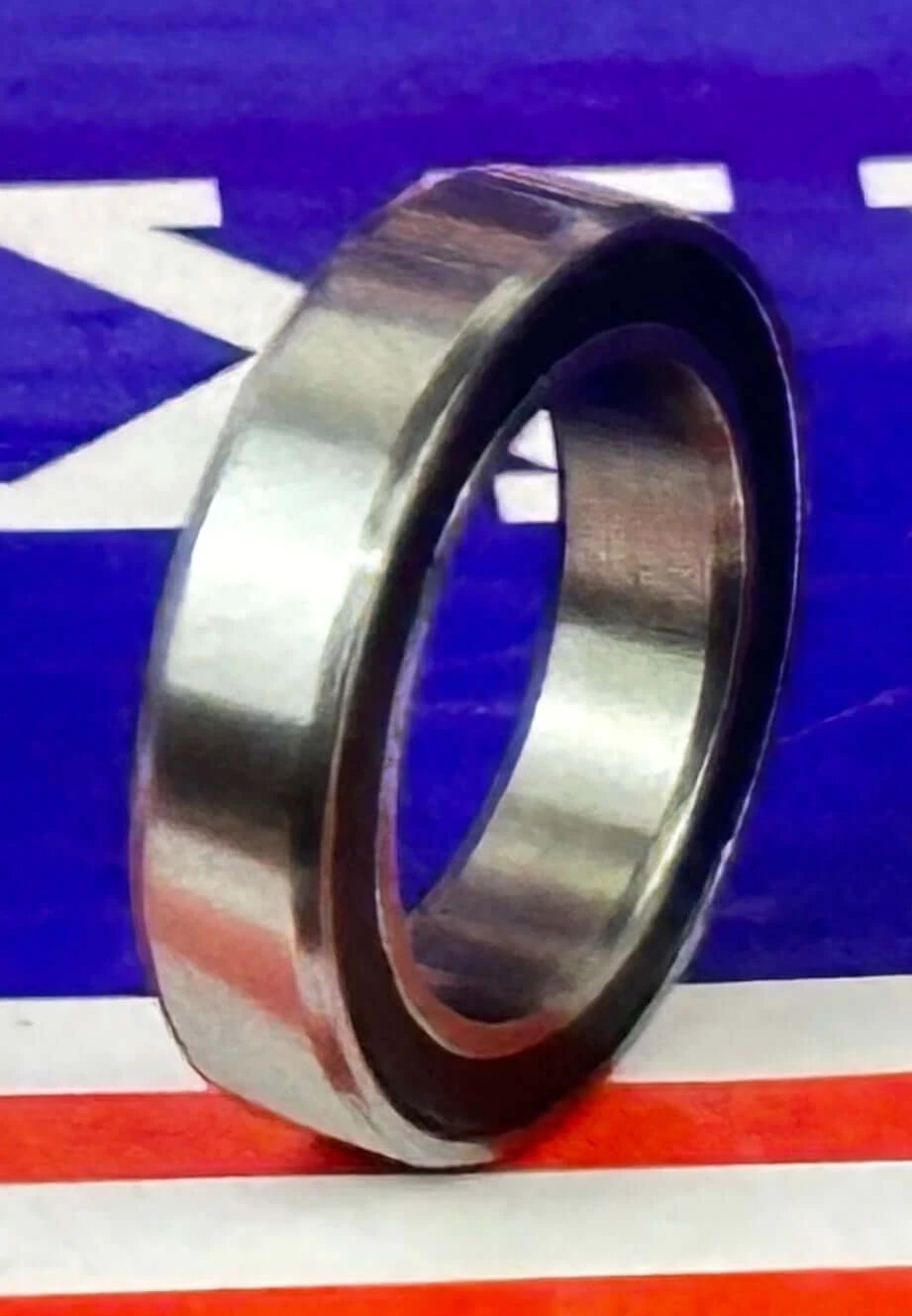 Premium 6701-2RS Bearing 12x18x4 Sealed Ball Bearing side view showing the smooth finish and rubber seal.