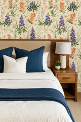 Floral pattern Hill Country Bloom Wallpaper with wildflowers and greenery, against a beige textured background.