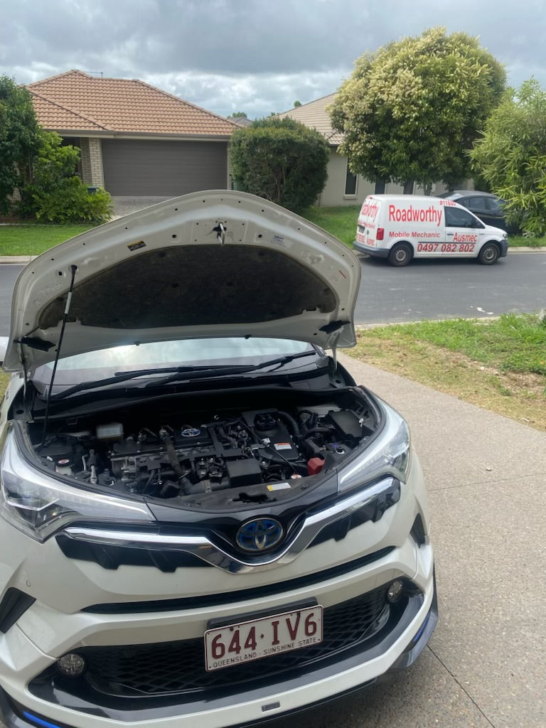 Car with open trunk in a residential area - A thorough engine inspection and full OBD scan during a pre purchase car inspection in a Clontarf seller's driveway.