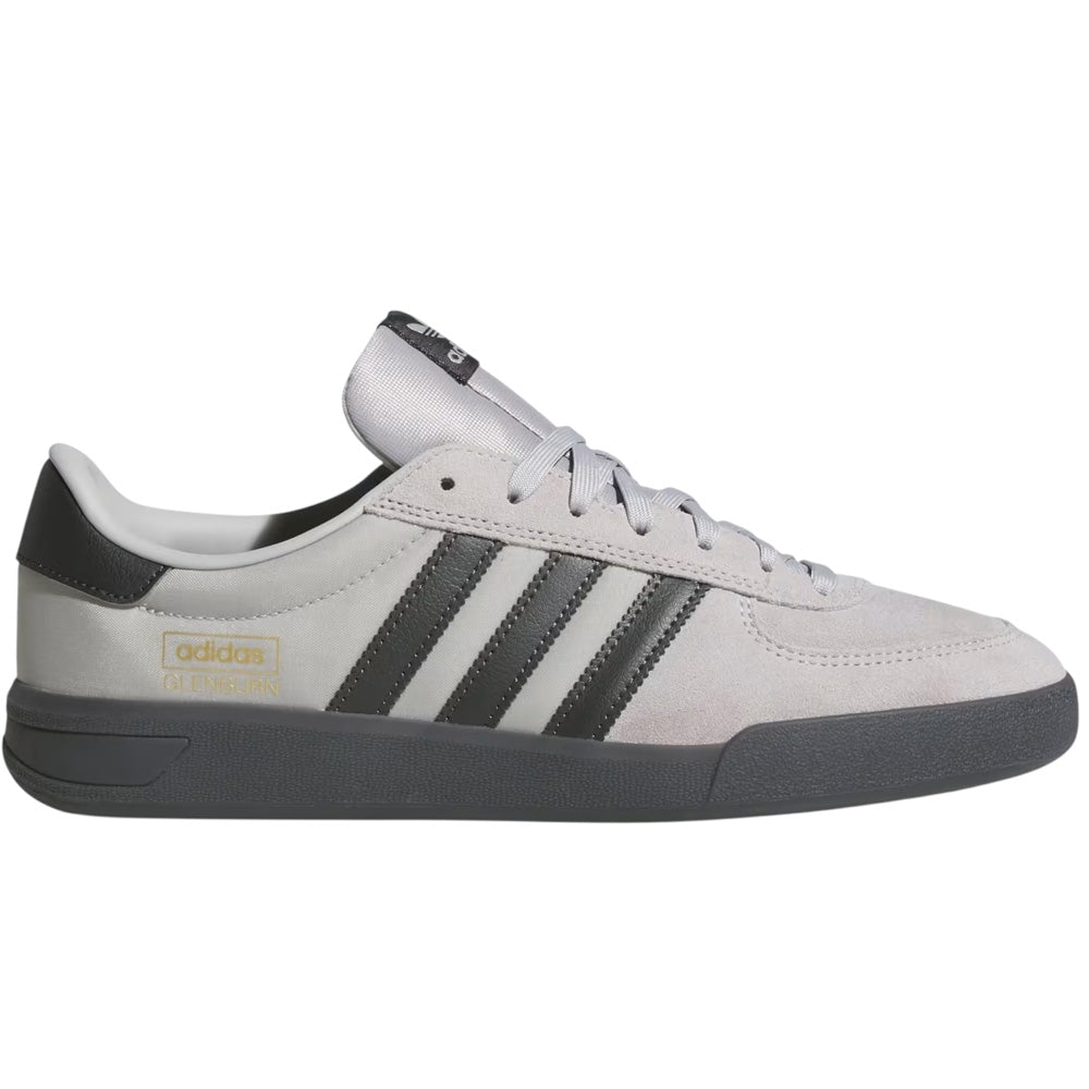 The Glenburn Grey HP3513 Adidas Skateboarding Shoes feature a light gray leather upper, black stripes and heel, black sole, gold Adidas CLASSPIC branding, and a classic low-top lace-up design.