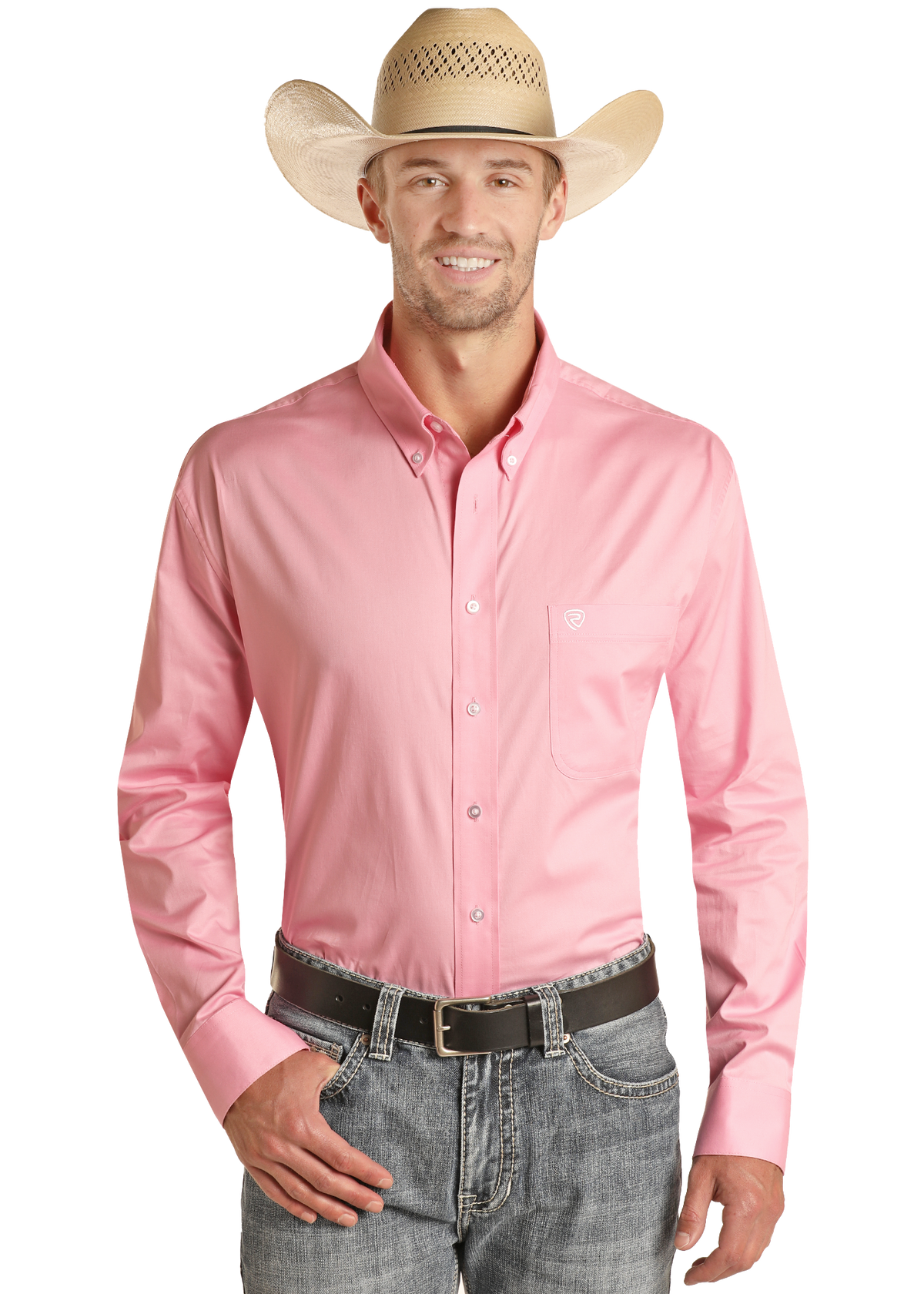 A man stands smiling with one hand in his pocket against a white background, wearing a Rock & Roll Denim Regular Fit Pink Long Sleeve Button Shirt, blue jeans, a black belt, and a straw cowboy hat.