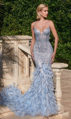 A woman stands on a stone staircase beside lush greenery, wearing the light blue Feather-Trim Long Beaded Mermaid Prom Dress CC2308 with a fitted silhouette and feathered trim.