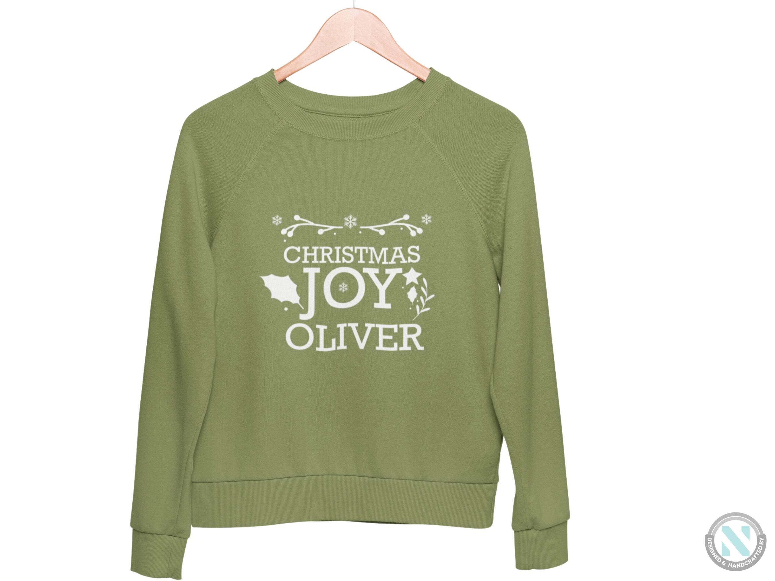 a green sweatshirt with the words christmas joy over it