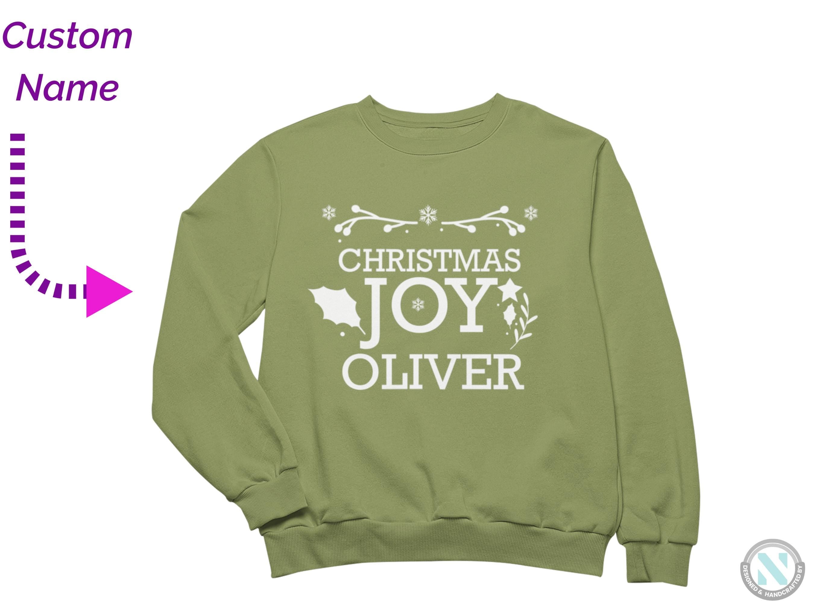 a green christmas sweatshirt with the words christmas joy over it