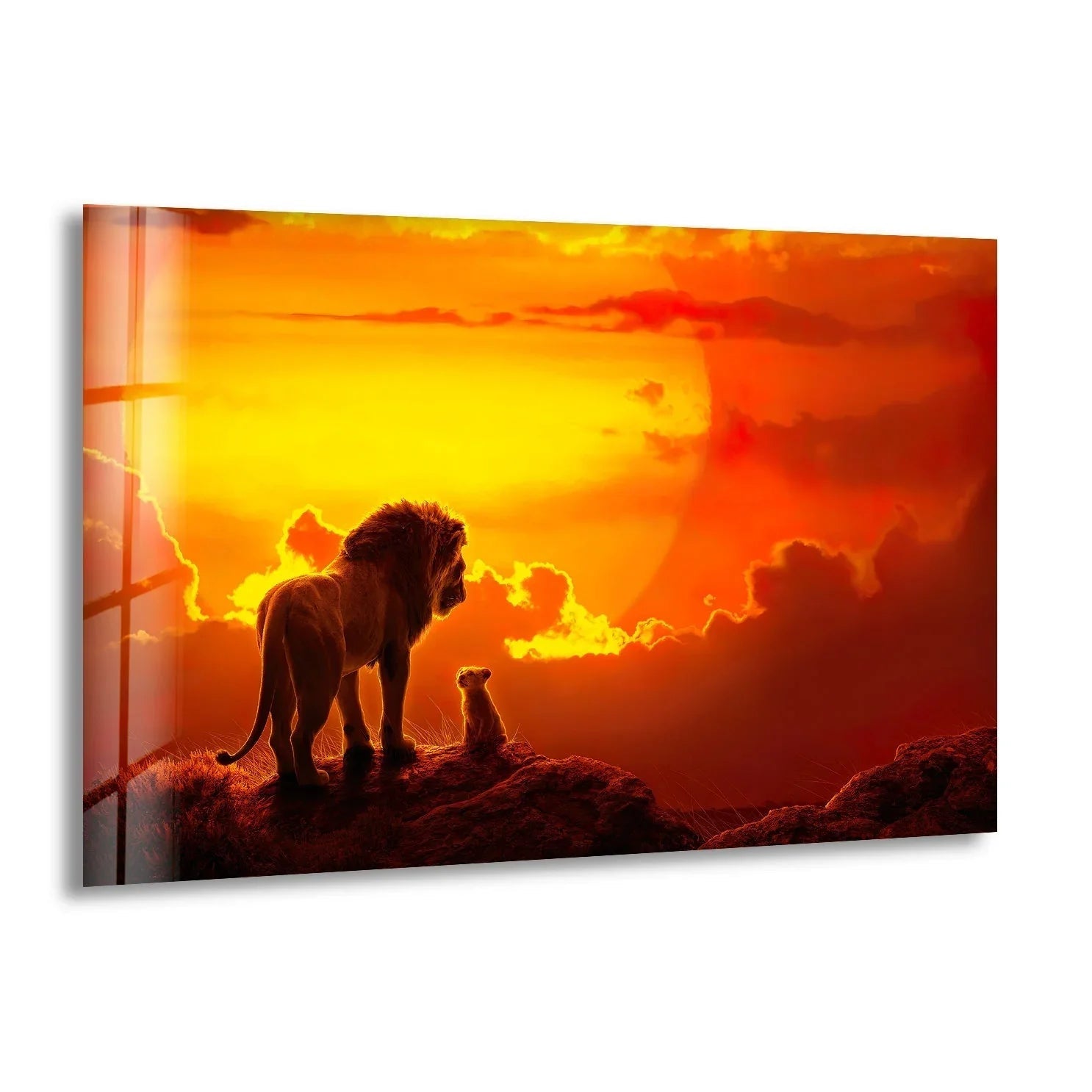 A panoramic glass wall art print depicts a lion and cub silhouetted against a vibrant sunset sky.