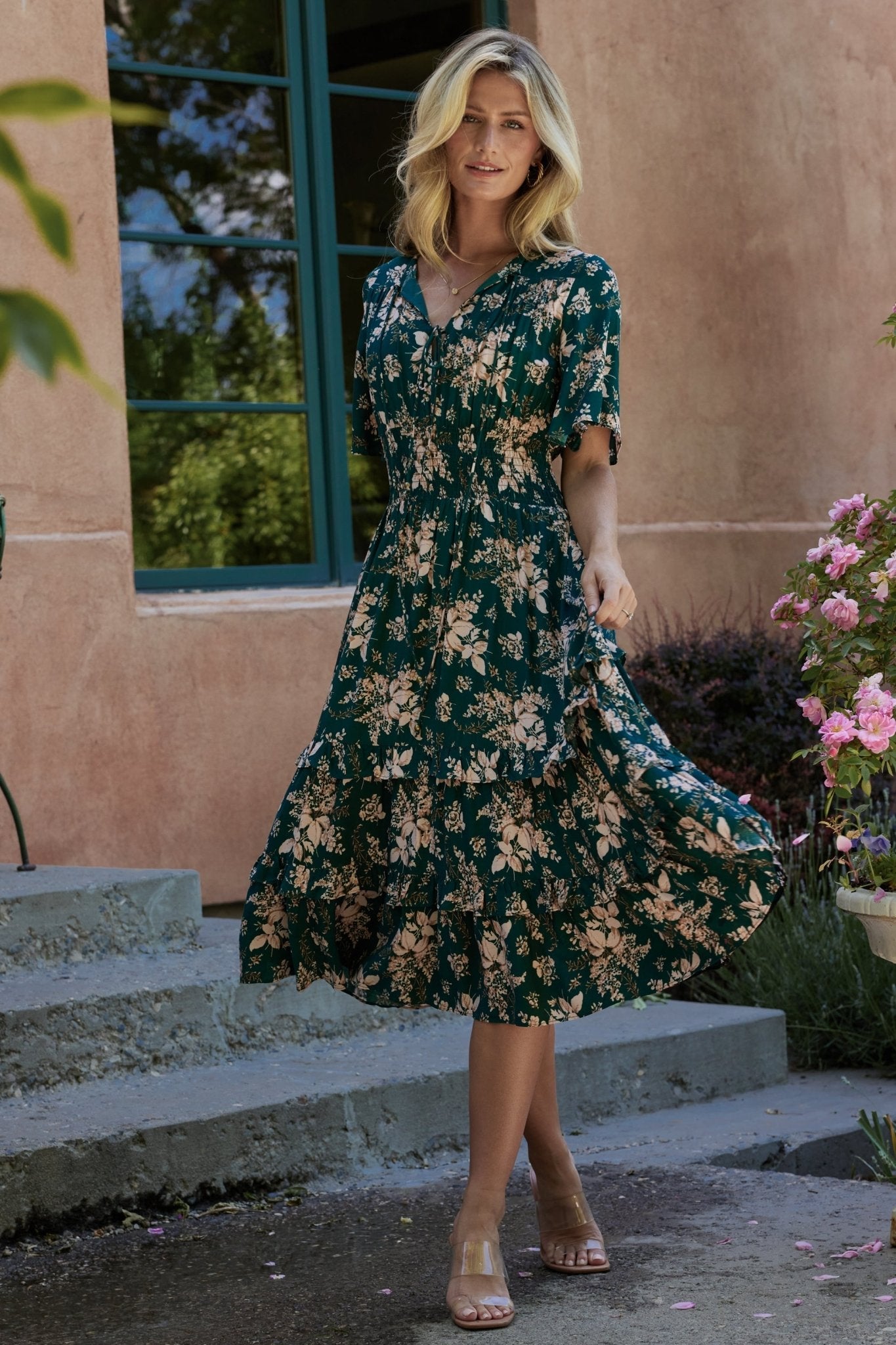 Front view of Spell Boho Midi Dress in topaz with blush floral print on model, V-neckline, smocked waist and midi hem, full outfit shot.